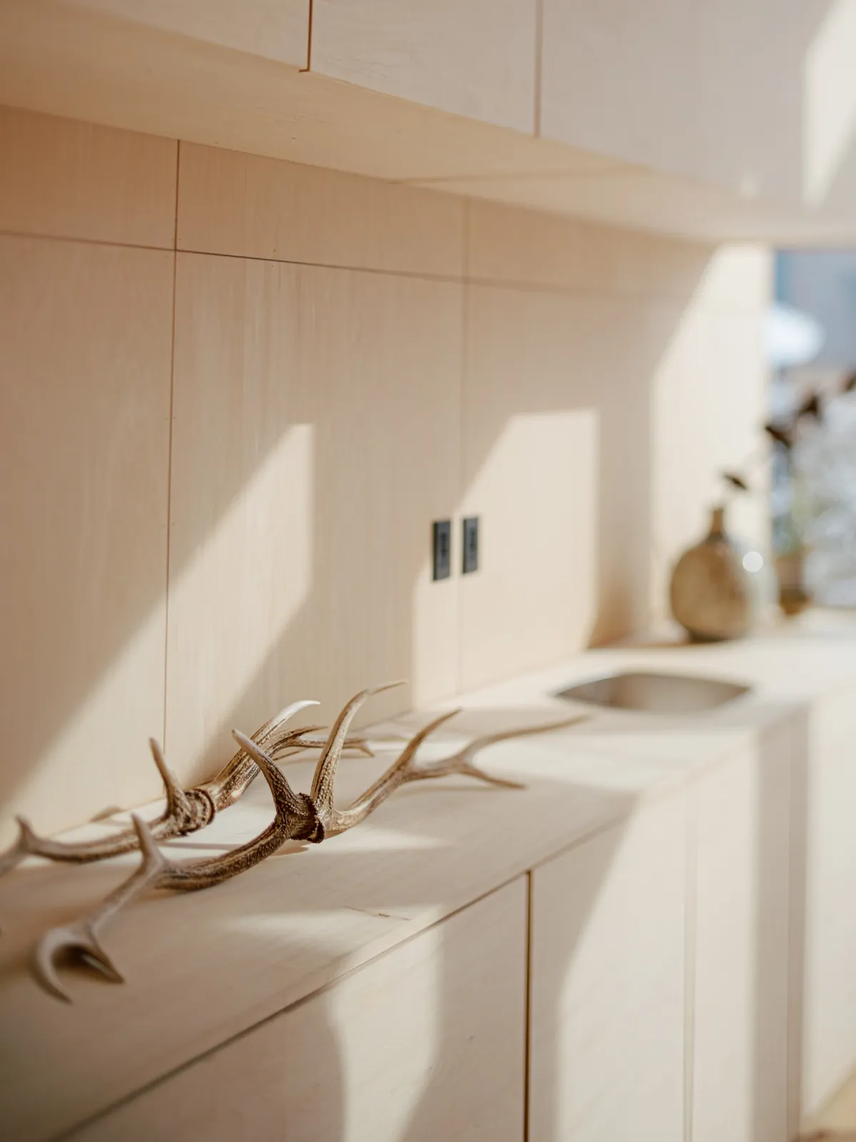 Plywood joinery detail with antler decoration, AK Housing, Niseko