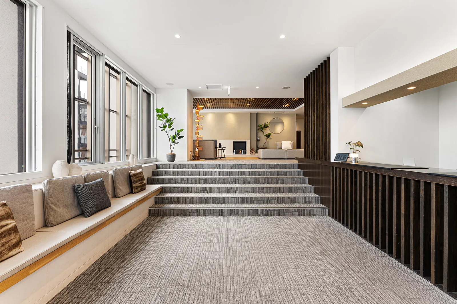 Stepped seating and cushions leading to the lounge in the Alpen Ridge Hotel Niseko lobby