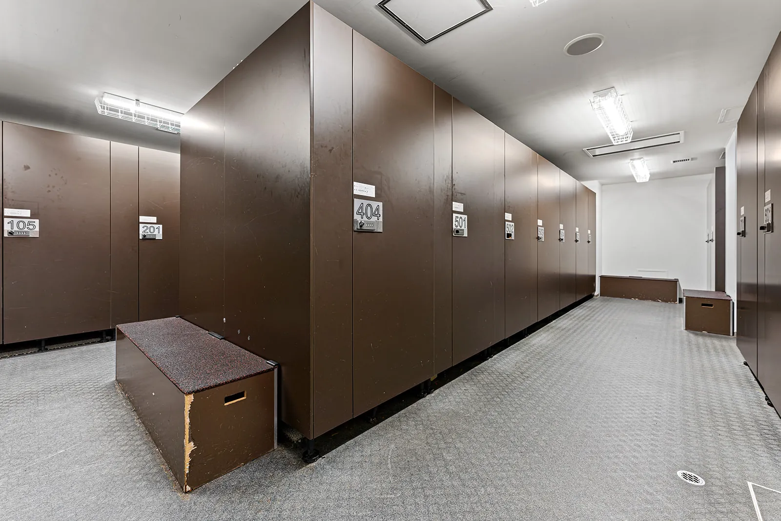 Ski locker room with numbered timber lockers and benches at Alpen Ridge Hotel Niseko