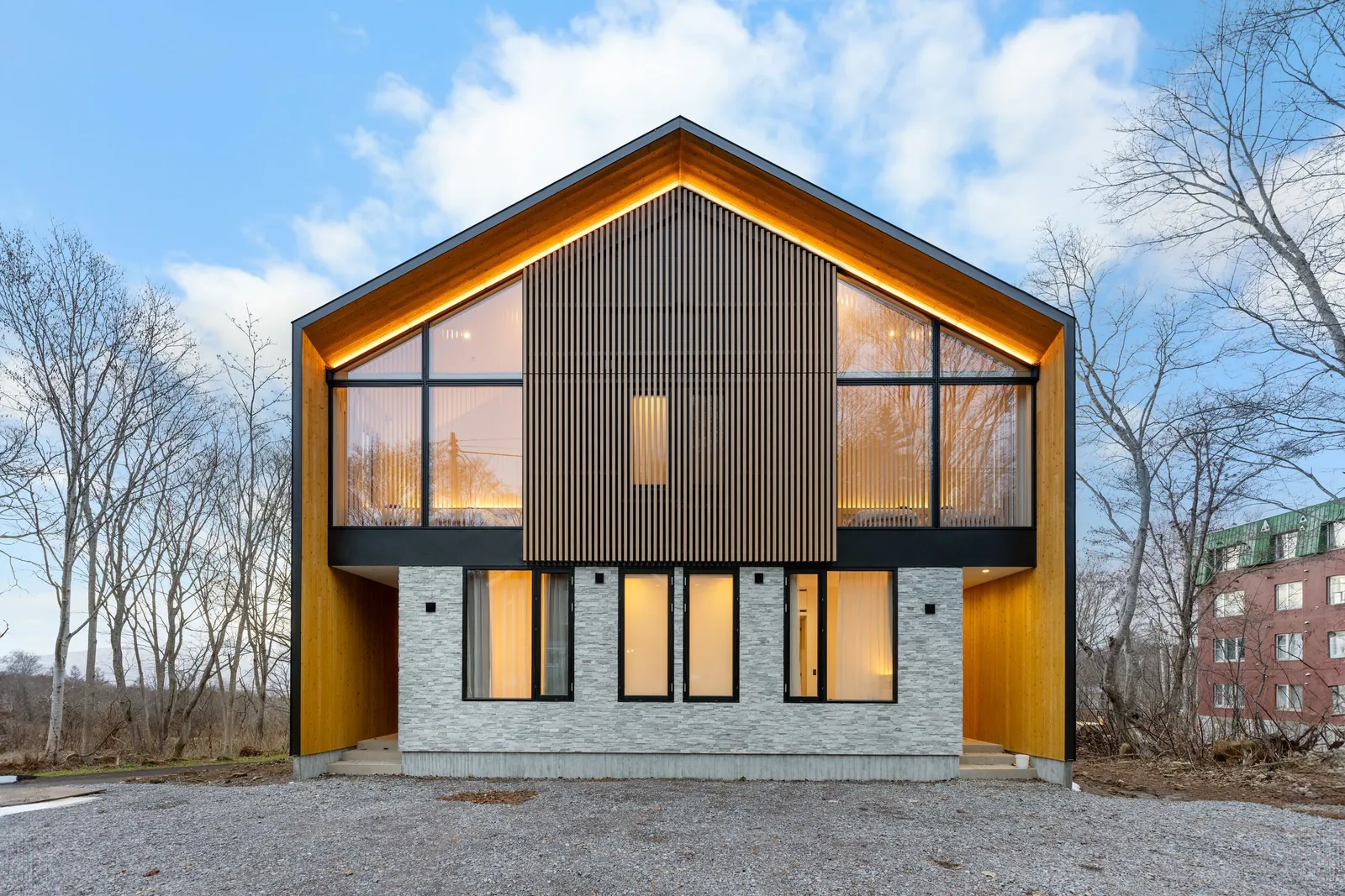 Aoyama Villa Niseko gable facade with timber framed glazing