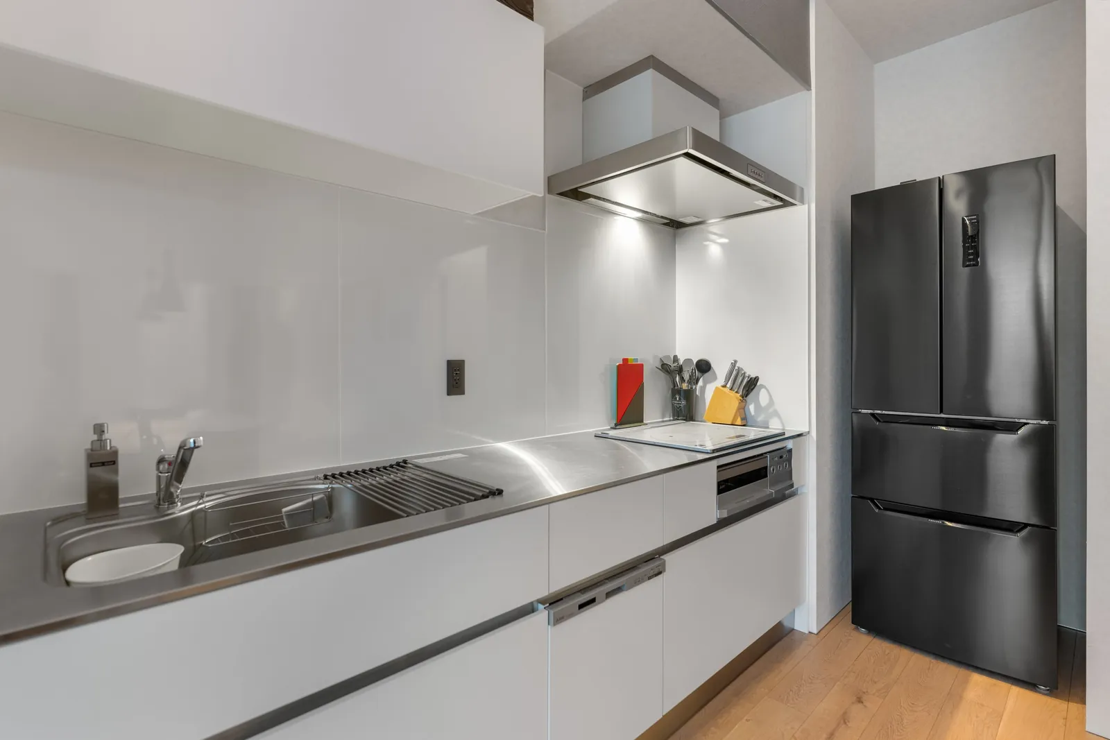 Kitchen with black fridge at Bisha Niseko