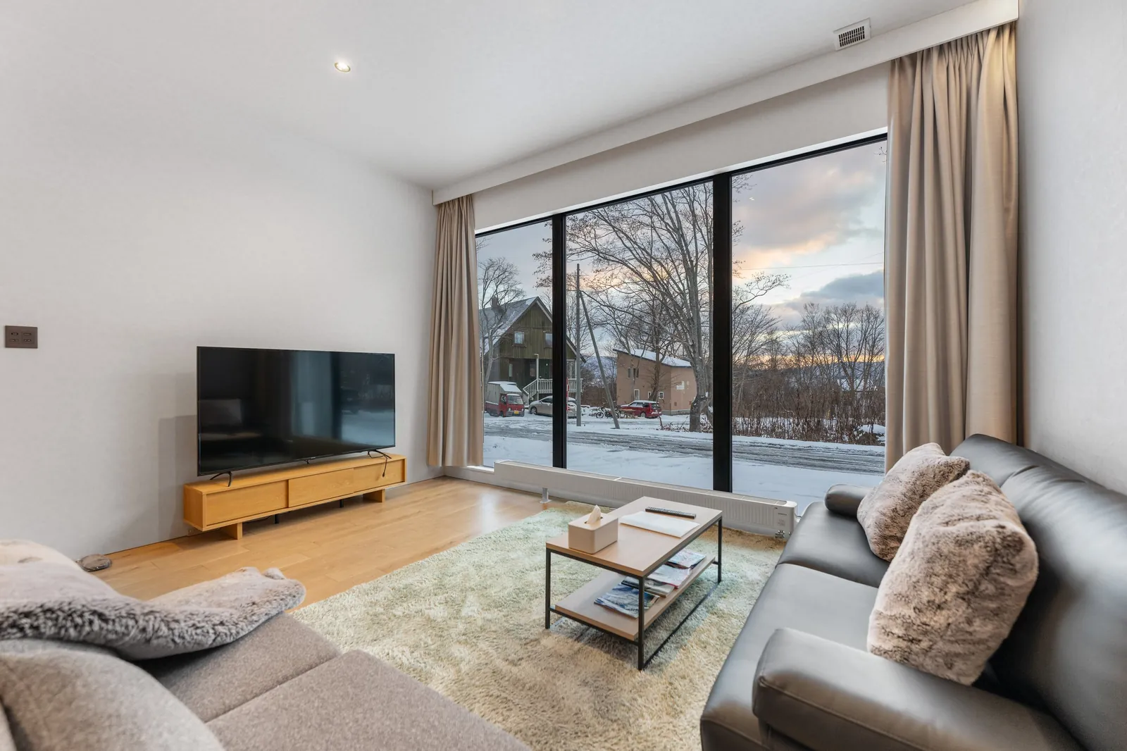 Living room with leather sofas at Bisha Niseko