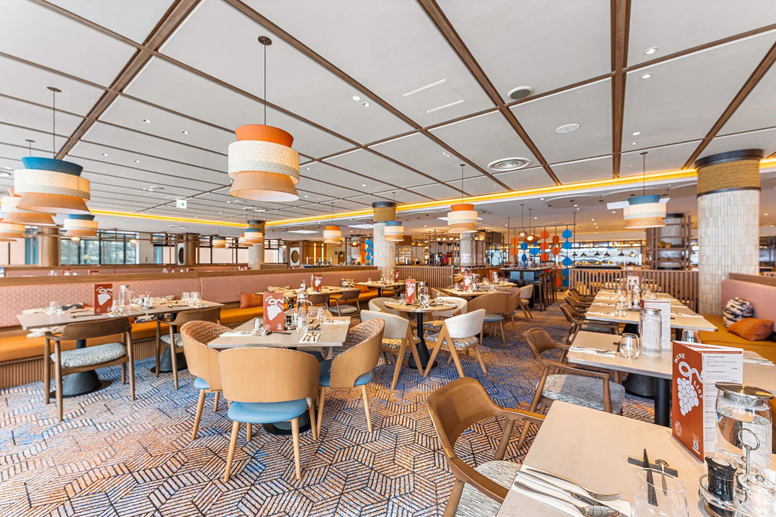 Daichi main restaurant dining room at Club Med Sahoro with drum pendant lights and patterned carpet