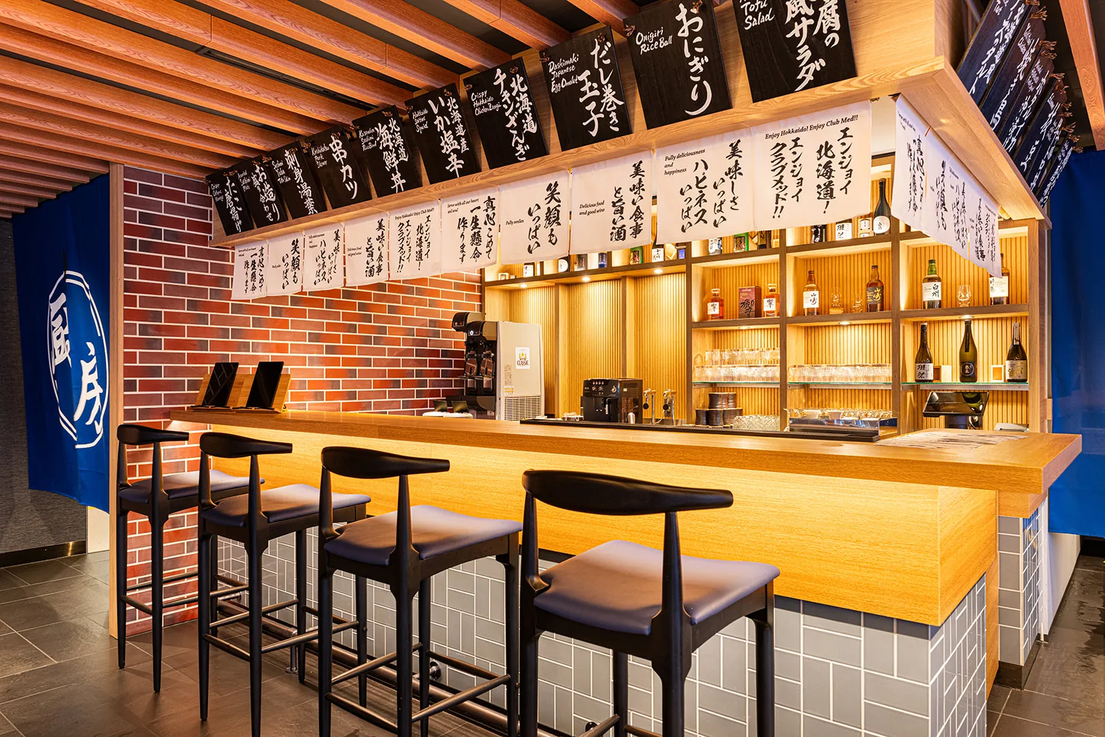Izakaya style bar counter with handwritten menu boards in Mina Mina, Club Med Sahoro