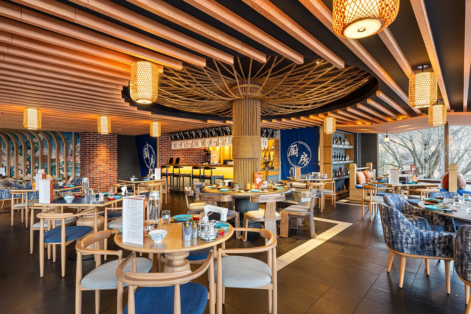 Mina Mina specialty restaurant at Club Med Sahoro Hokkaido, with a woven timber umbrella canopy and paper lanterns