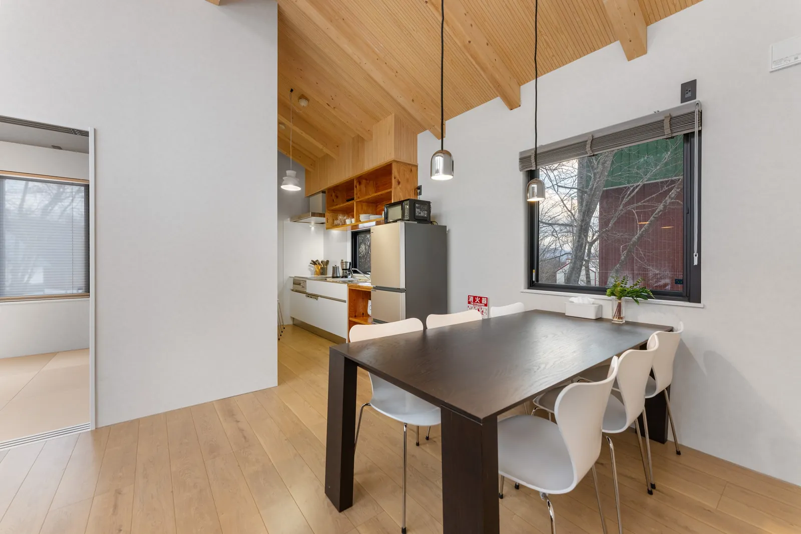 Dining table under a timber ceiling at Dreamlife Niseko