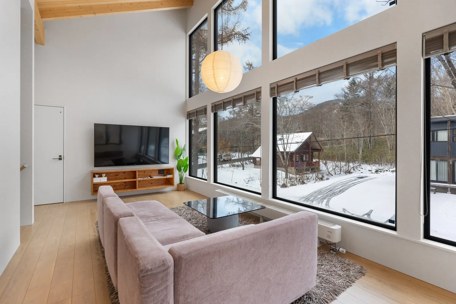 Living room with large windows at Dreamlife Niseko