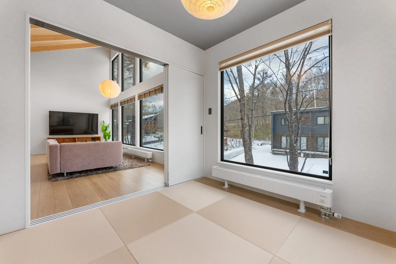 Tatami room opening to the living room at Dreamlife Niseko
