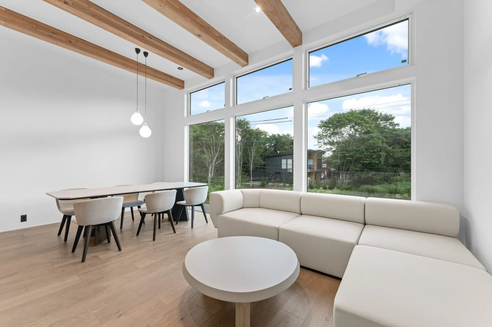 Living and dining room with tall windows at Hikari Hanazaki