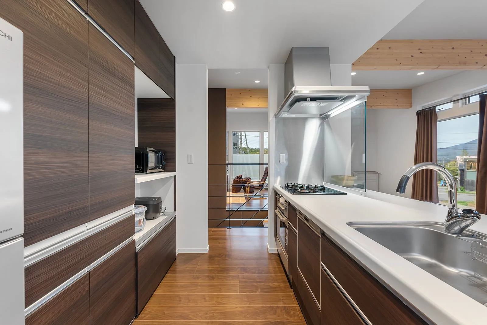 Kitchen with timber cabinetry at Hikari House, Hirafu