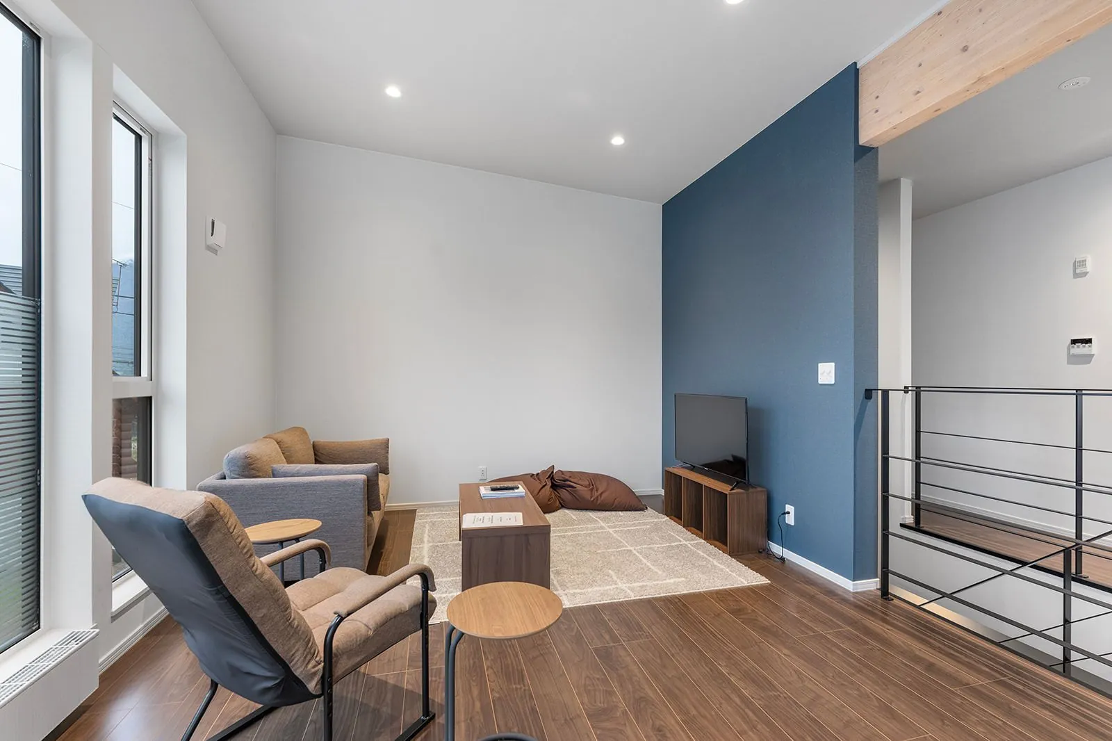 Living room with blue feature wall at Hikari House