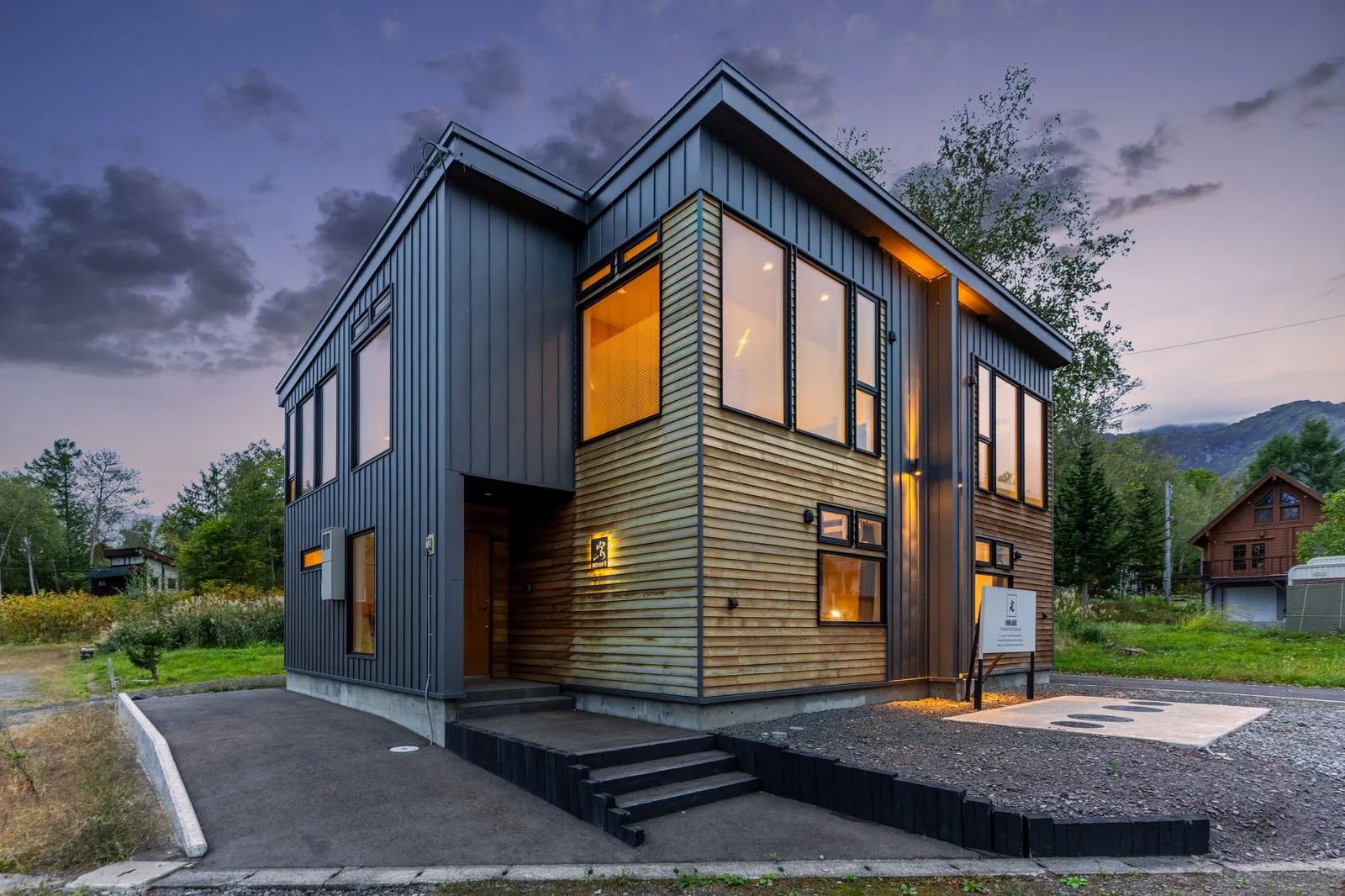 Hikari House townhouse in Hirafu, Niseko, lit at dusk