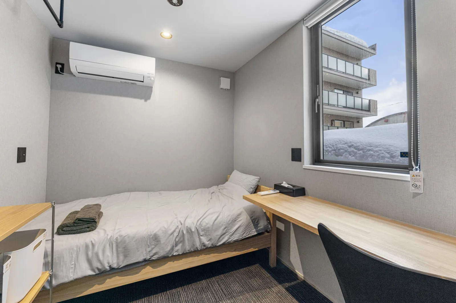 MOD Kutchan bedroom with desk and snowy window view