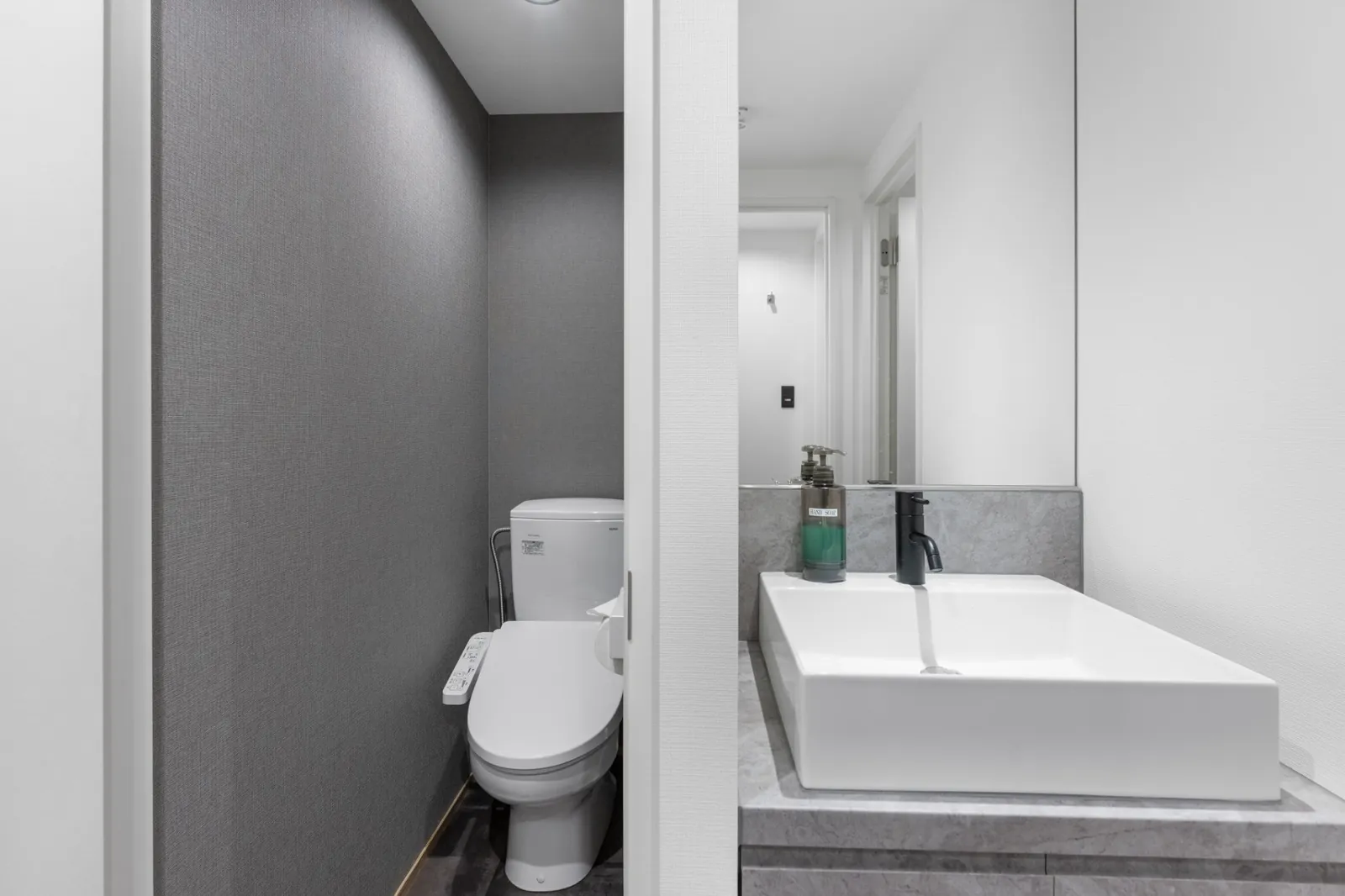 MOD Kutchan toilet and vanity with grey tiles