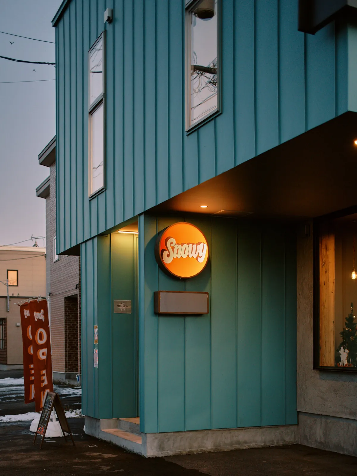Snowy Cafe Niseko entrance and round sign