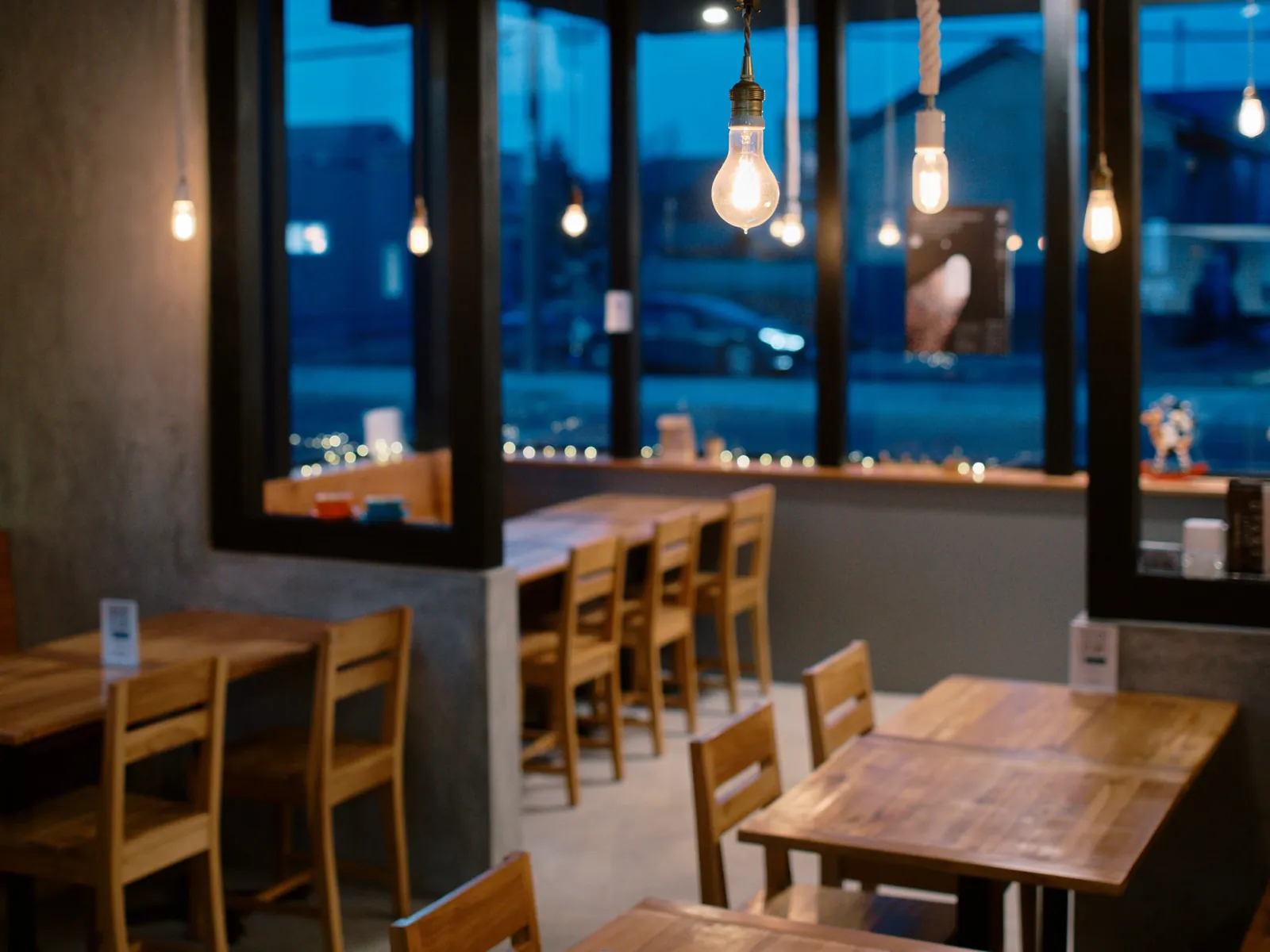 Window seating with pendant bulbs at Snowy Cafe Niseko